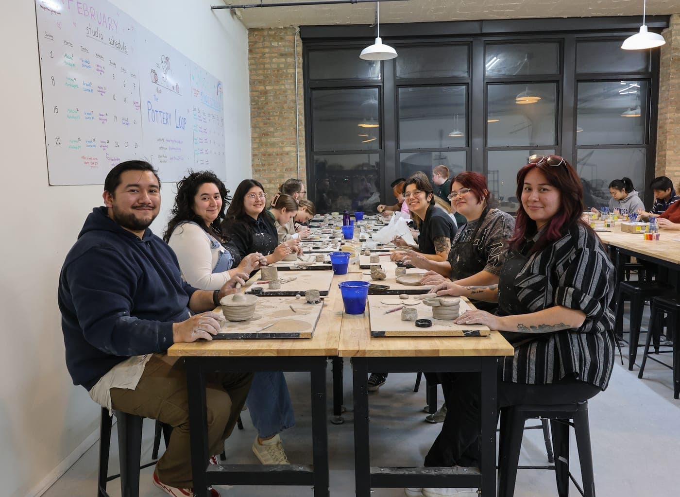 A full handbuilding class at work around the long table at The Pottery Loop