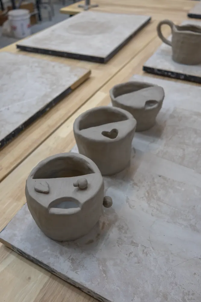 Chicago Girls Who Walk members with their pottery at a past social at The Pottery Loop