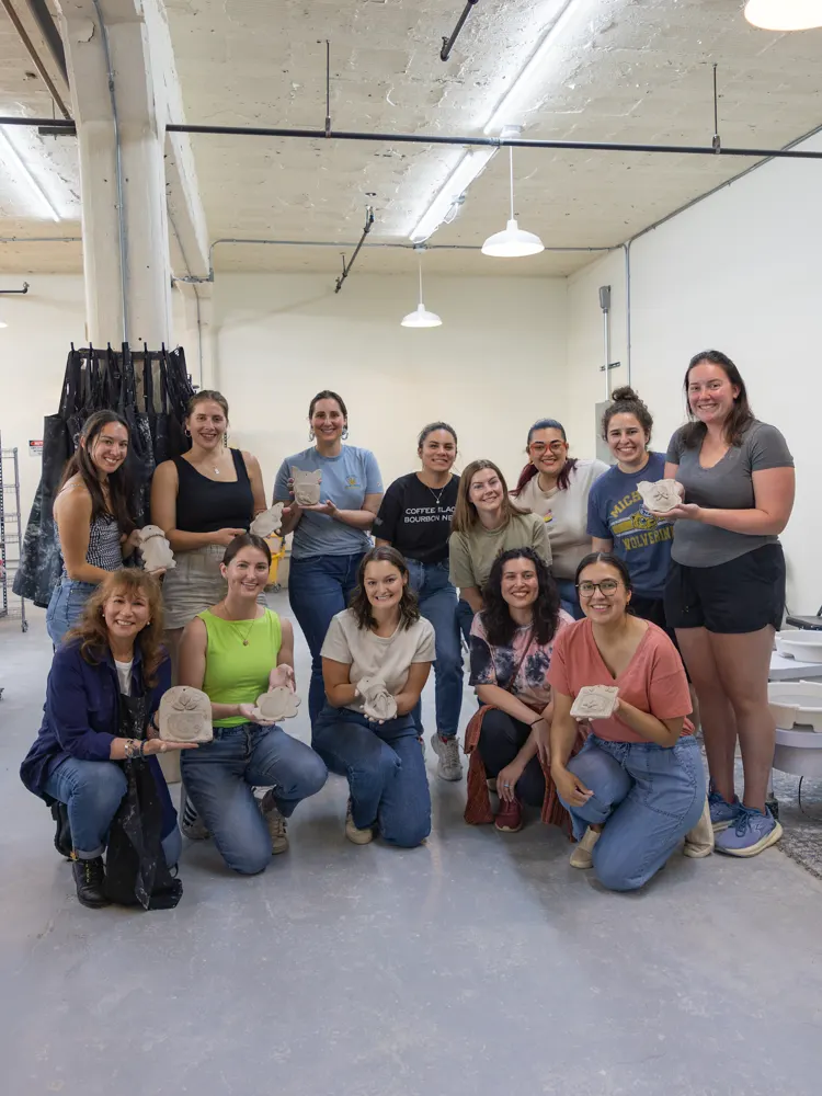 Chicago Girls Who Walk members with their pottery at a past social at The Pottery Loop