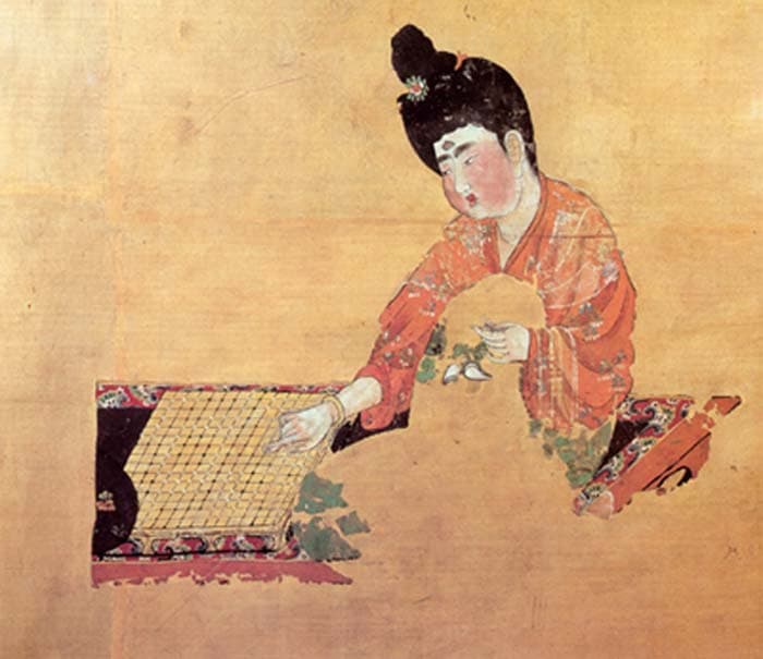 Detail of a woman concentrating over a board game