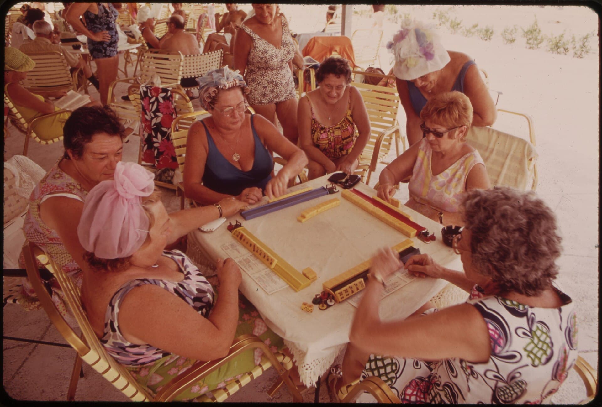 Color photograph of a group of women playing mahjong at an outdoor clubhouse table