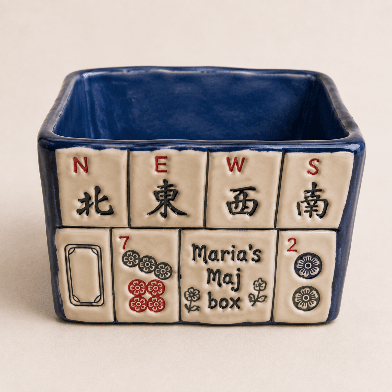 Blue glazed ceramic storage box with mahjong wind and dot tiles around the outside
