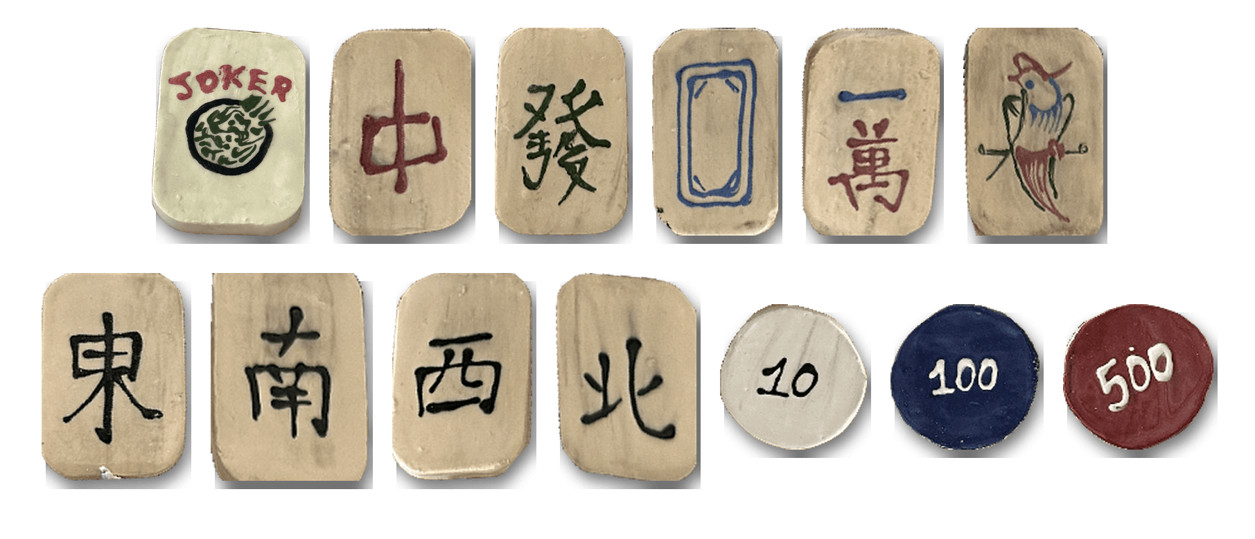Finished, fired mahjong tiles (joker, the three dragons, the four winds, one character, and one bamboo) with 10, 100, and 500 counting chips