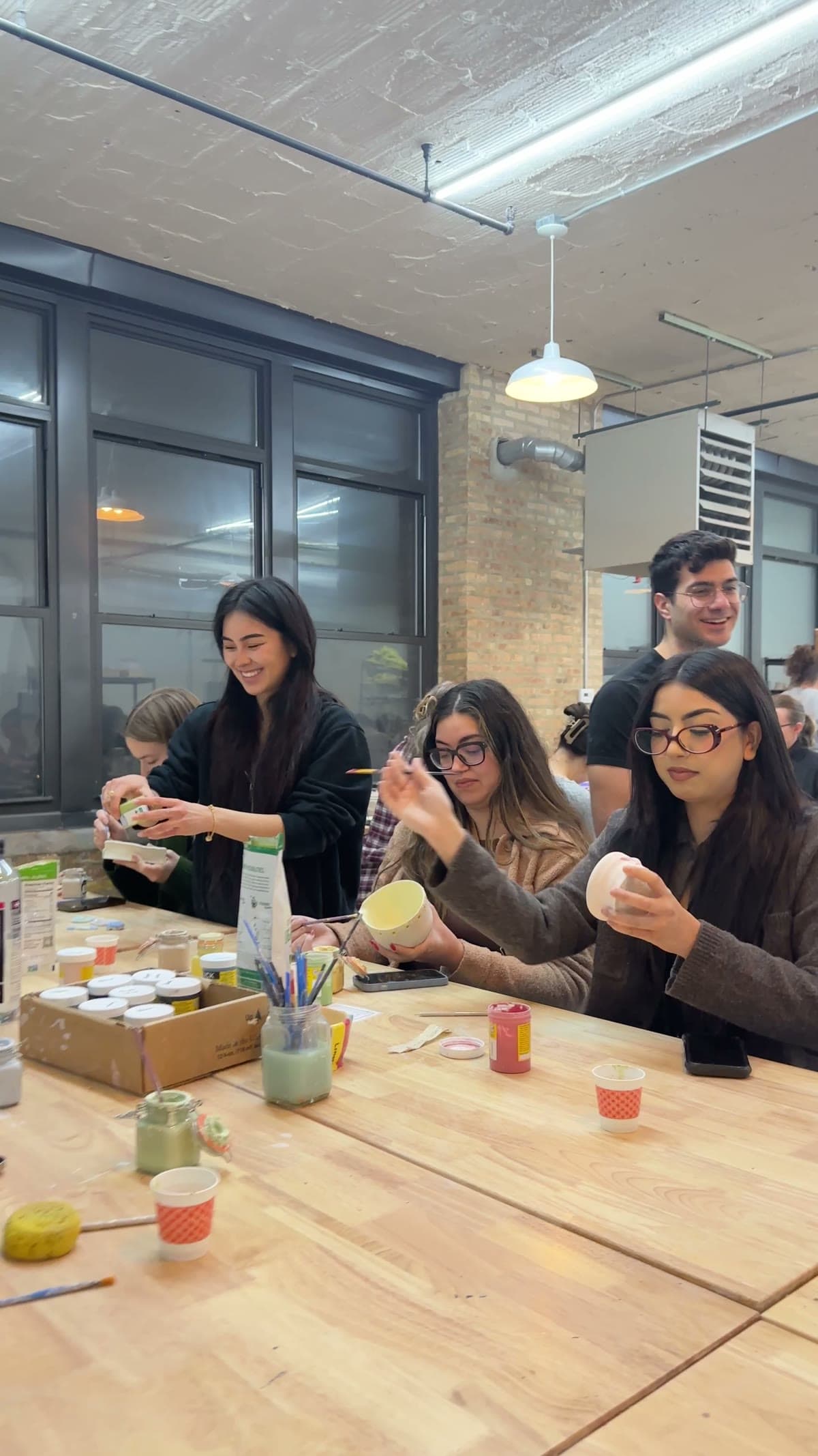 Guests glazing handmade bowls with matcha at The Pottery Loop