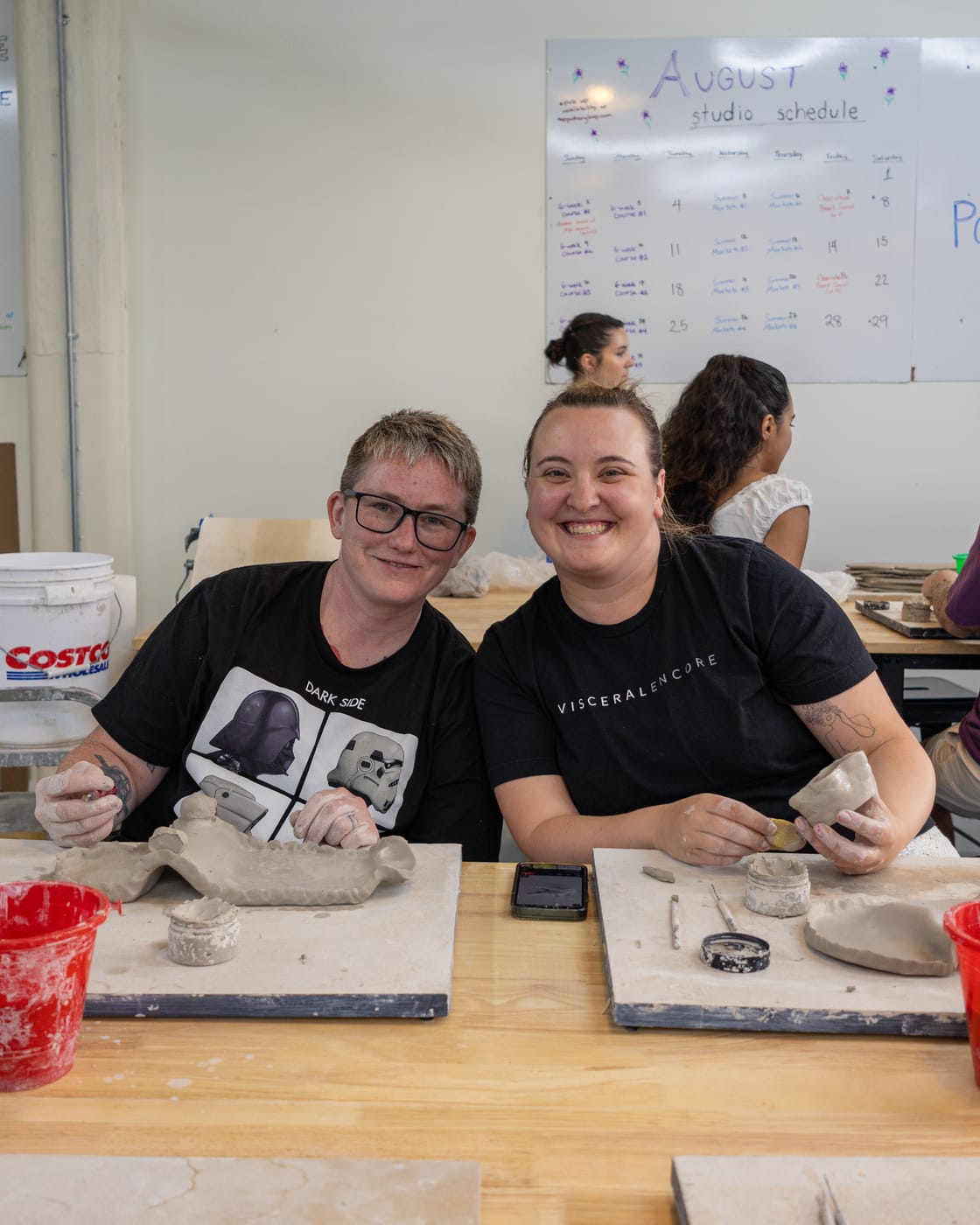 Two friends laughing while they build at the table